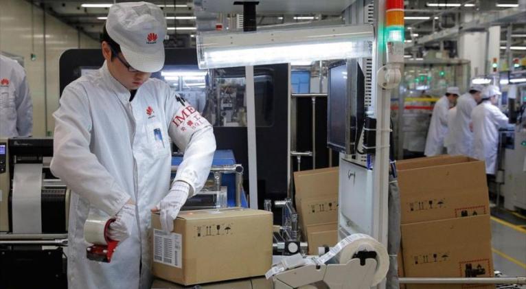 Personal de una línea de producción de teléfonos móviles en una fábrica de Huawei en Dongguan, China, 6 de marzo de 2019. Foto: AP