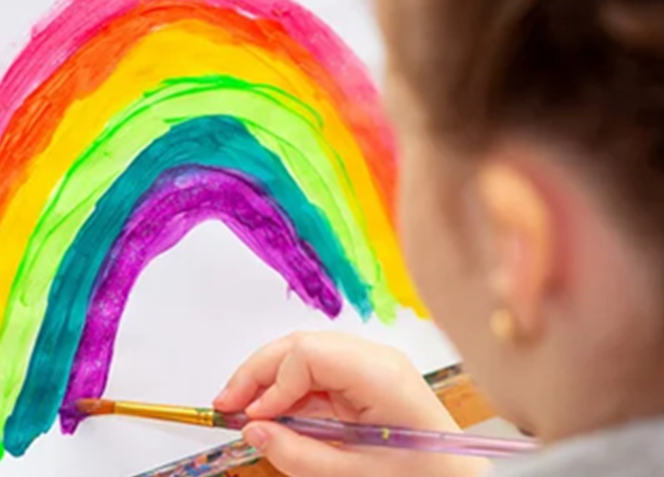 Niña pintando un arcoíris
